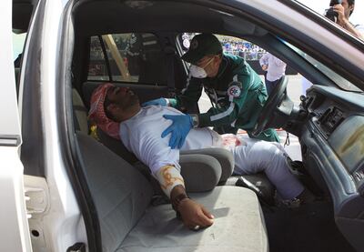 ABU DHABI - 16MAR2011 - Police Ambulance team rescuing a passenger and driver of a car on the "Mock Accident" scene organised by Abu Dhabi Police as part of GCC Traffic week yesterday at Abu Dhabi Corniche. Ravindranath K / The National