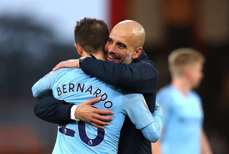 Manchester City manager Josep Guardiola embraces Bernardo Silva following the Premier League match between AFC Bournemouth and Manchester City at Vitality Stadium in Bournemouth. Getty Images