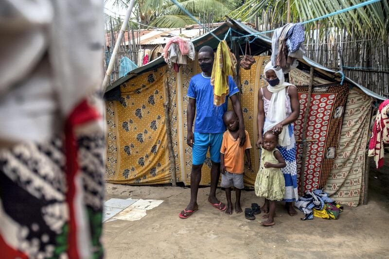 Ali Issa (L) and his wife Asha Ambas, who moved with their two children to the Paquitequete neighborhood in Pemba City after armed insurgents attacked the Macomia district, pose for pictures in Paquitequete on February 23, 2021. (Photo by Alfredo Zuniga / AFP)
