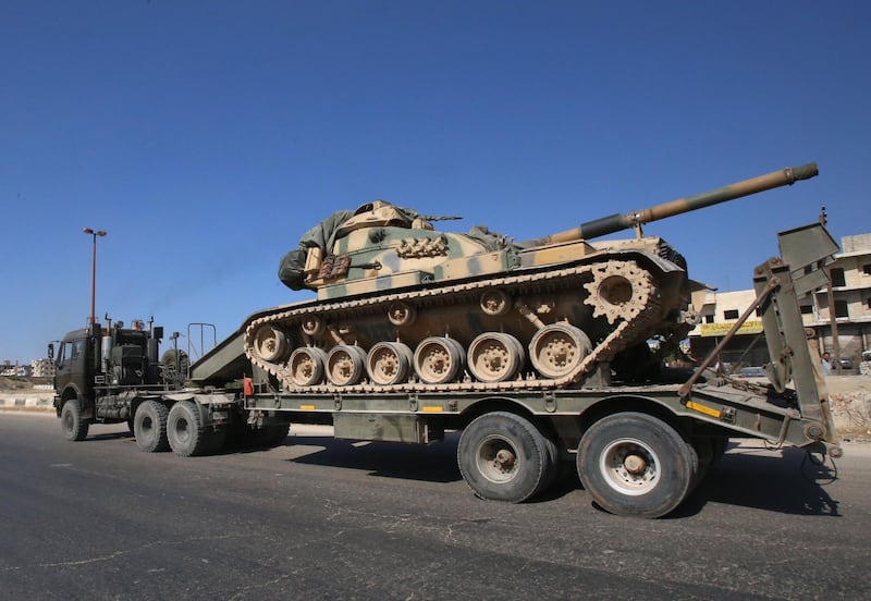 Inhabitants of Maaret Al Numan in Syria's northern province of Idlib watch a convoy of Turkish military vehicles reportedly headed to assist rebels against regime forces. AFP