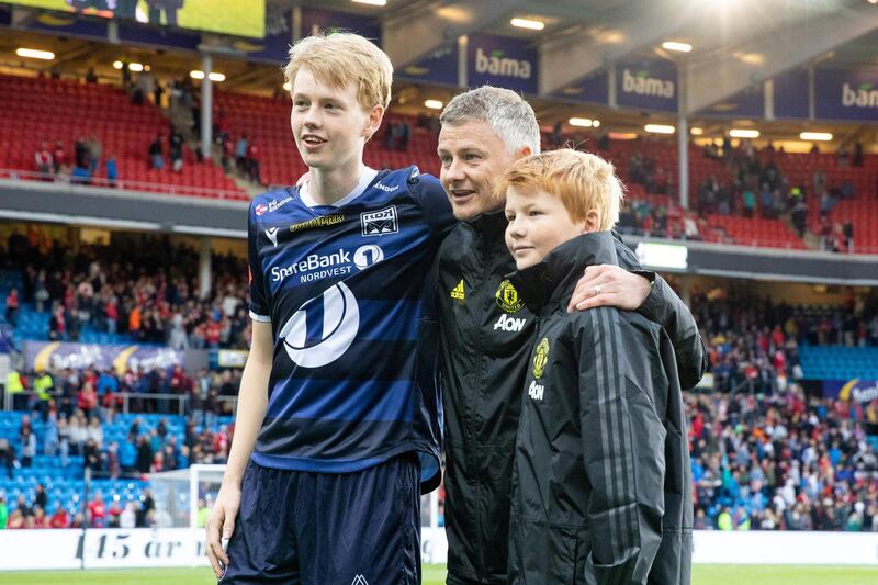 Solskjaer poses with his sons Elijah Solskjaer and Kristiansund's Noah Solskjaer. Reuters