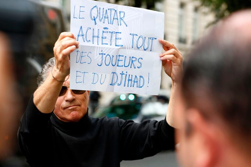 A bystander holds a placard which translates as " Qatar buys everything, some players and some Jihad", as a vehicle, understood to be transporting the entourage of Brazilian footballer Neymar after he arrived on August 4, 2017, arrives at a hotel in Paris, following his world record 222 million euro ($260 million) transfer from Barcelona to Paris Saint-Germain.
Paris Saint-Germain have signed Brazilian forward Neymar from Barcelona for a world-record transfer fee of 222 million euros (around $264 million), more than doubling the previous record. / AFP PHOTO / Benjamin CREMEL