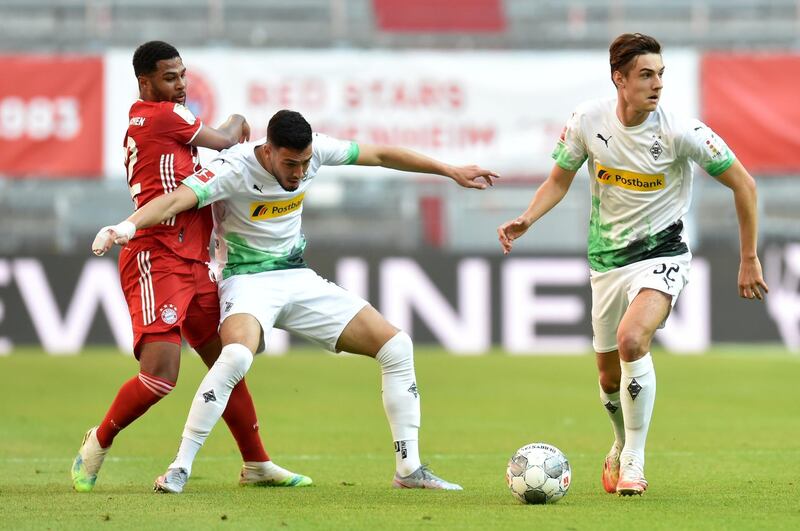 Bayern Munich's Serge Gnabry in action with Borussia Monchengladbach's Florian Neuhaus and Ramy Bensebaini. Reutes