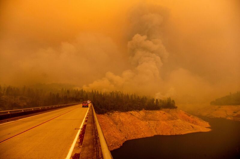 A plume rises from the Bear Fire as it burns along Lake Oroville, in Butte County, California. AP Photo