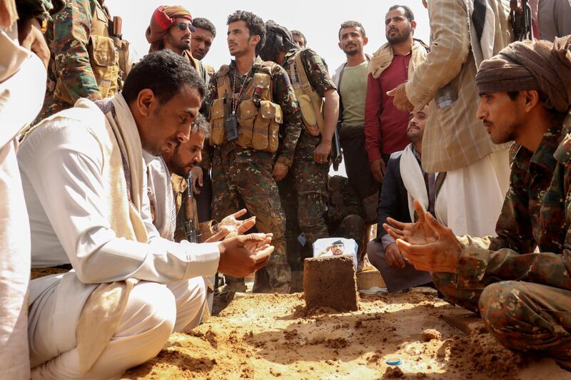 Soldiers recite prayers next to the grave of Brigadier General Abdul-Ghani Shaalan, Commander of the Special Security Forces in Marib who was killed in recent fighting with Houthi fighters in Marib, Yemen February 28, 2021. REUTERS/Ali Owidha