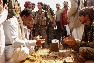 Mourners gather by the grave of Brig Gen Abdul Ghani Shaalan, commander of Special Security Forces in Marib, Yemen, who was killed in fighting with Houthi rebels in February. Reuters.