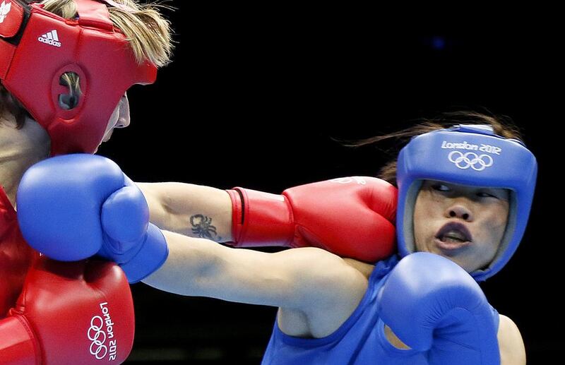 Karolina Michalczuk, left, of Poland defends against Chungneijang Mary Kom Hmangte of India during the women's flyweight boxing round of 16 on August 5, 2012, at the 2012 London Olympic Games. Jack Guez / AFP