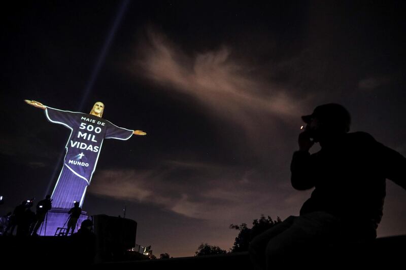Christ the Redeemer with a projection in tribute to the victims of Covid-19 that reads 'More than 500 thousand lives', in Rio de Janeiro, Brazil.  EPA