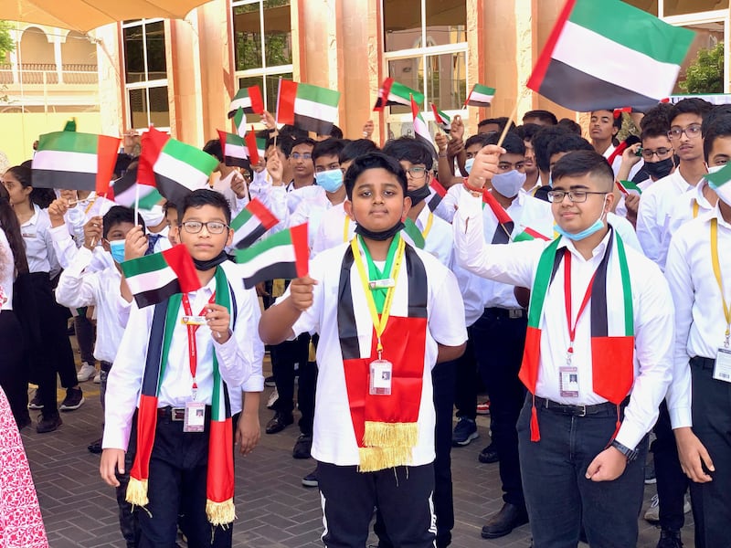 Pupils at The Indian High School celebrate with their UAE flags. Pawan Singh / The National 