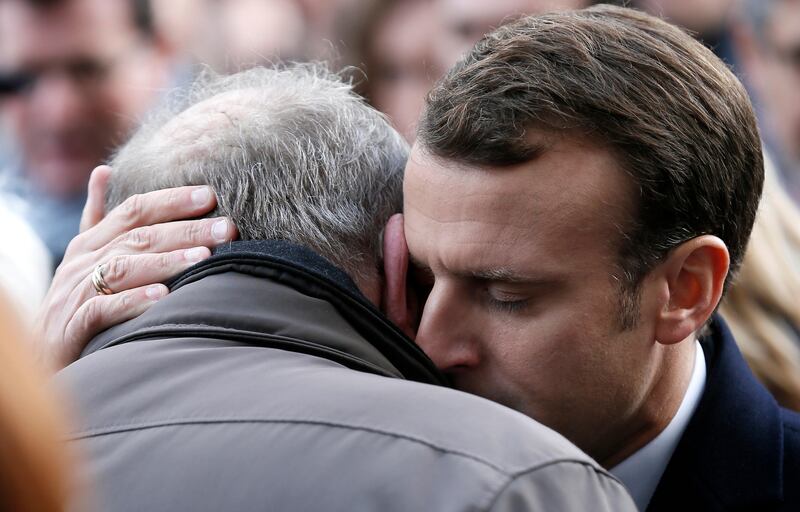 French president Emmanuel Macron hugs a relative of a victim at the Bataclan concert hall during a ceremony marking the second anniversary of the Paris attacks. Etienne Laurent / Pool via AP