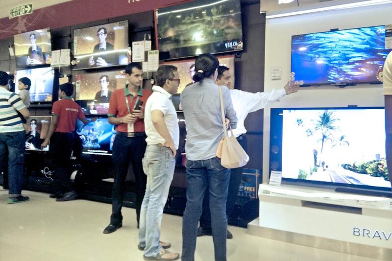 Shoppers look at TVs in the Oberoi Mall in Mumbai. Manufacturing of electronic good in India is still relatively low making  imports a burden on the country's trade deficit.