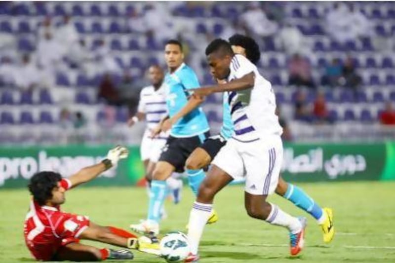Al Ain’s Asamoah Gyan, right, gets past the Baniyas defence for one of his two goals on Sunday. The match ended in a 2-2 draw. Satish Kumar / The National