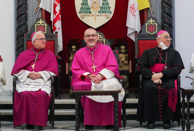 Pierbattista Pizzaballa, centre, the Latin Patriarch of Jerusalem, waits before crossing into Bethlehem to attend Christmas celebrations in Jerusalem. Reuters