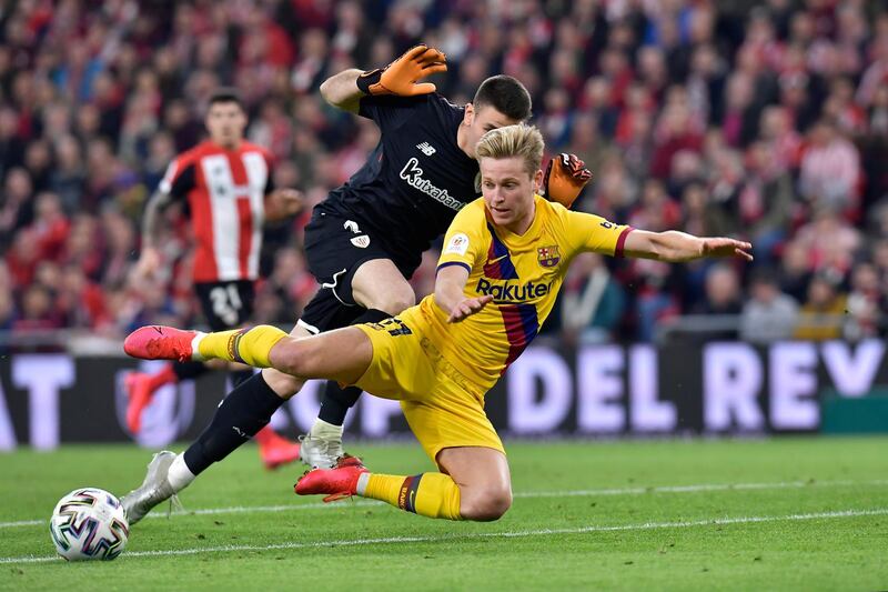 Barcelona's Frenkie de Jong fights for the ball with Athletic Bilbao goalkeeper Unai Simon. AP