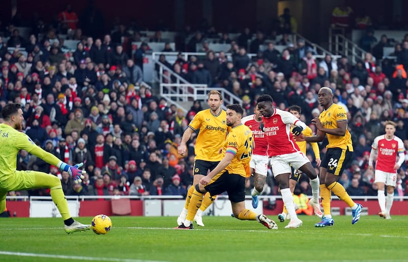 Arsenal's Bukayo Saka scores their first goal against Wolves. PA 