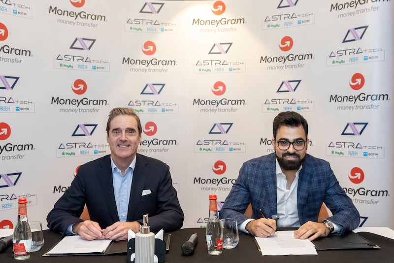 (From left) Grant Lines, MoneyGram's chief revenue officer, and Abdallah Abu Sheikh, Astra Tech’s founder and Botim’s chief executive, sign an agreement offering money transfer services on the internet calling platform. Credit: Astra Tech and MoneyGram