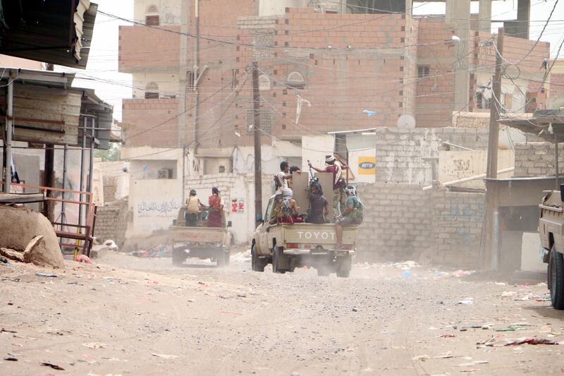 A convoy drives through a built-up area near Hodeidah.