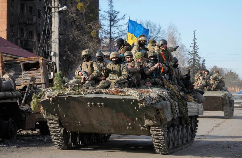 Ukrainian soldiers ride an armoured people carrier through the town of Trostsyanets, about 400 kilometres east of Kyiv. AP Photo