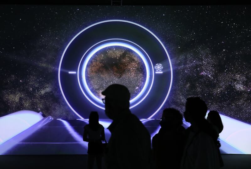 Visitors watch an audio-visual show at the Australia Pavilion at the Expo site in Dubai