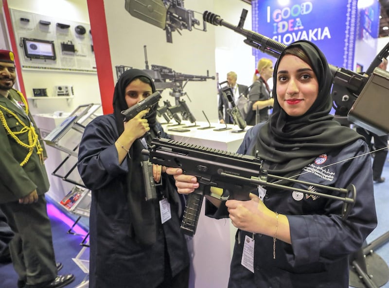 Abu Dhabi, U.A.E., February 18, 2019. INTERNATIONAL DEFENCE EXHIBITION AND CONFERENCE  2019 (IDEX) Day 2--  Lady visitors check out some firearms at the exhibition. Victor Besa/The National