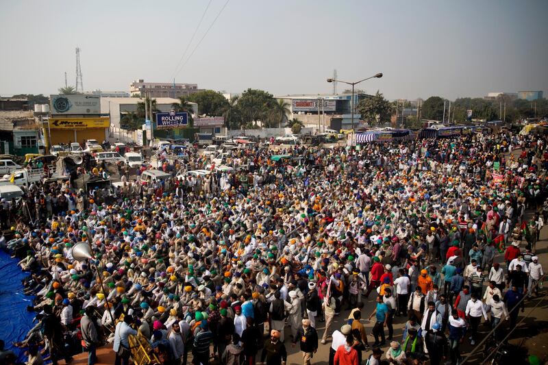 Farmers listen to a speaker as they block a major highway during a protest at the Delhi-Haryana state border, India.  Talks between protesting farmers and the Indian government failed.  AP