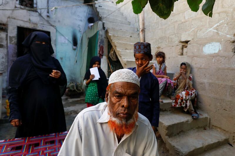 Fisherman Mohammad Sabir, 60, sits at his house with his family during in Ibrahim Hyderi fishing village on the outskirts of Karachi, Pakistan. Reuters