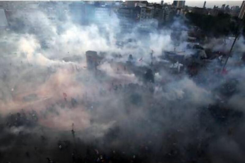 Protesters run to avoid tear gas during clashes at Istanbul's Taksim Square.