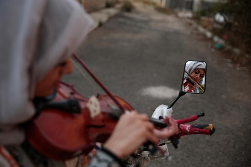 A female Yemeni music student practices playing the violin during a music class at the Cultural Centre in Sanaa, Yemen, on April 8, 2018. For the young people who receive lessons from Abdullah El-Deb'y, music is a safe haven from the misery of Yemen’s devastating war. El-Deb’y offers free lessons to students eager to escape the suffering caused by the war and is seeking to form a national orchestra comprised of young Yemenis. Hani Mohammed / AP Photo