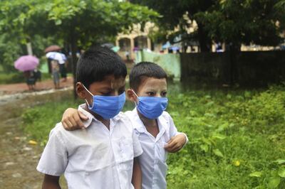 epa09298214 Students wearing face masks leave form Min Gan primary school in Sittwe, Rakhine State, western Myanmar, 24 June 2021. According to a report from the Ministry of Health and Sports, cases of coronavirus disease (COVID-19) are on the rise in Myanmar's Rakhine State.  EPA/STRINGER