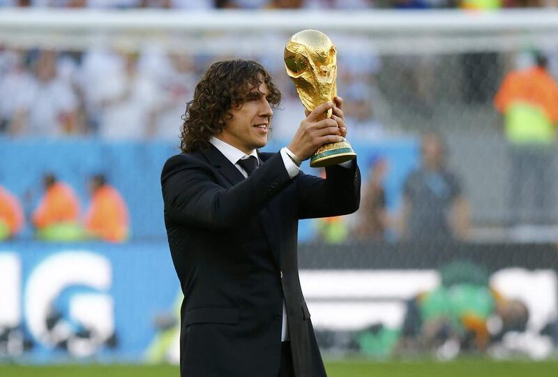Retired footballer Carles Puyol of Spain, a member of the 2010 World Cup-winning team, holds the World Cup trophy before the final. Kai Pfaffenbach / Reuters