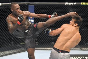 Israel Adesanya lands a kick to the head of Paulo Costa during their middleweight title fight at UFC 253 in Abu Dhabi. Josh Hedges / Zuffa LLC