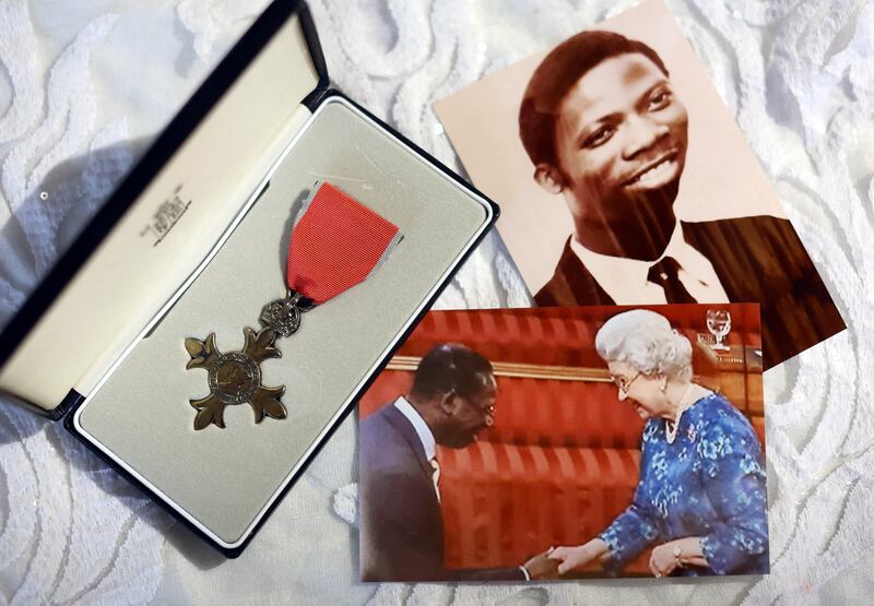 A portrait from 1953 of Reverend Milton Job and a photograph from 2008 of Queen Elizabeth II awarding him with an MBE on display at the Celestial Church of Christ, in south-east London