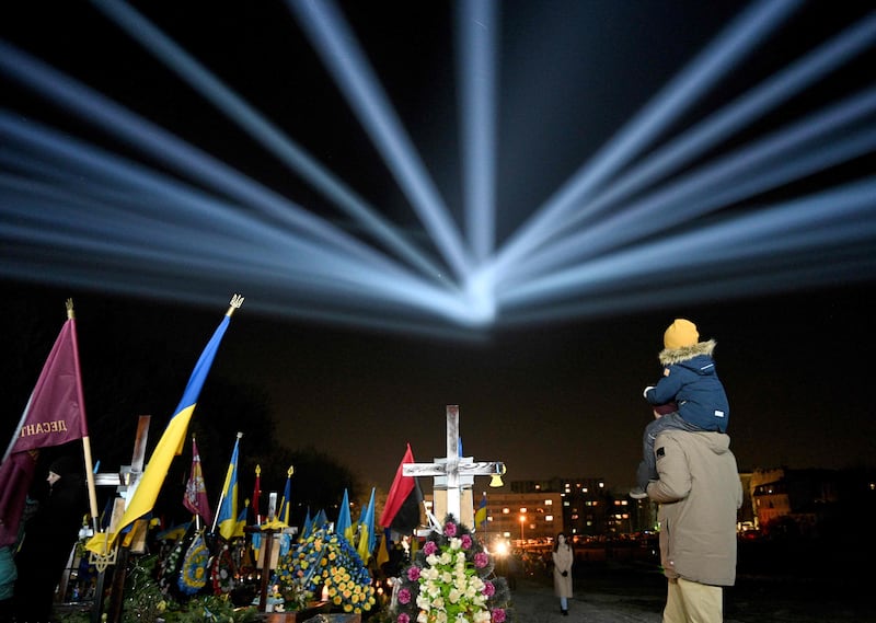 Illuminations over the graves of Ukrainian soldiers who died in the war with Russia at Lychakiv Cemetery in Lviv, on the eve of the first anniversary of the invasion. AFP