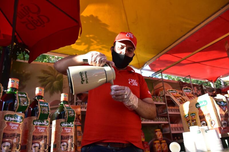 A man serve a drink during a shopping festival in Damascus, Syria. EPA