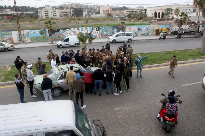 Protesters block cars from advancing on a main road in the southern Lebanese city of Sidon during a general strike by public transport and workers unions. AFP