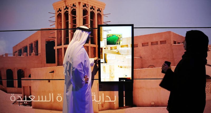 Employees use a touchscreen display on a wall in Dubai. Kamran Jebreili / AP Photo