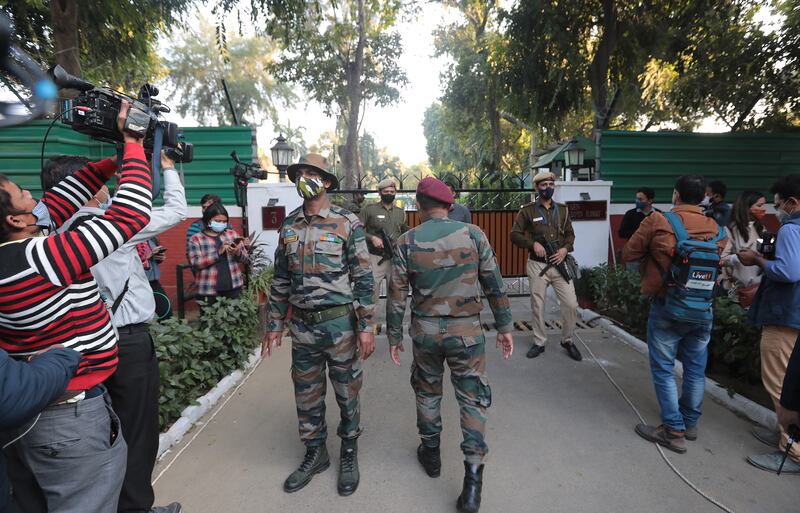 People gather outside the residence of Chief of Defence Staff Gen Bipin Rawat in New Delhi. A helicopter carrying him, his wife and several top military officials crashed in the hills of south India, killing 13 people on board, including the top official, the country's air force said. EPA