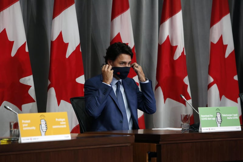 Justin Trudeau, Canada's Prime Minister, puts on a protective mask after a news conference in Ottawa, Ontario, Canada, on 25 September. David Kawai/Bloomberg