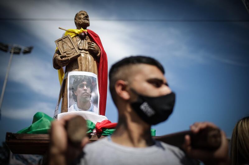 A man carries a  photo of Maradona at Villa Palito neigborhood in La Matanza municipality, Buenos Aires. EPA