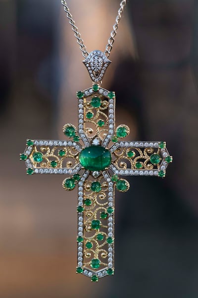 A cross pendant in yellow and white gold with emeralds and diamonds. Photo: Dolce & Gabbana