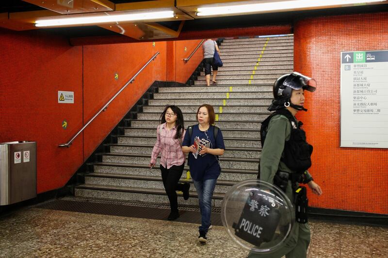 Passengers walk descend a flight of steps inside North Point station. Bloomberg