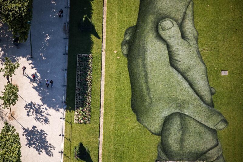 A general view taken from the Eiffel Tower shows the giant landart painting part of the project entitled 'Beyond Walls' by French artist Saype  in the Champs-de-Mars garden in Paris. EPA