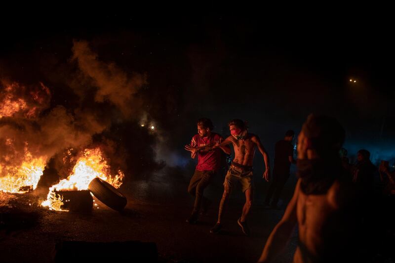 BEIRUT, LEBANON - JUNE 11:  Protesters burn tires as large-scale protests resume on June 11, 2020 in Beirut, Lebanon. The Lebanese pound has lost 70% of its value since October when protests began. Although they abated during the coronavirus lockdown, the country's economic condition steadily worsened. (Photo by Diego Ibarra Sanchez/Getty Images)