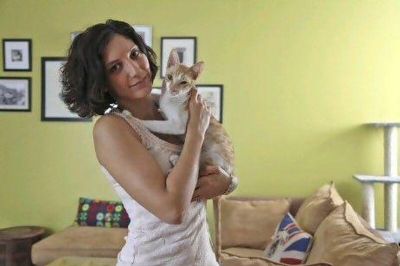 Kay Ivanova, a full time personal trainer, has just created a non profit called "38 Smiles". Using her house as the space, she brings in stray cats, takes care of them, and finds them good homes. The selection process of a new home for the animals is thorough as Ms. Ivanova would not want her kittens to end up with the wrong family. She is seen here inside her home.  Lee Hoagland/The National