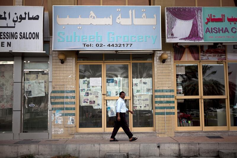 Abu Dhabi, United Arab Emirates, January 10, 2013: 
A man walks by the Suheeb Grocery, a recently closed convenience store on Thursday, Jan. 10, 2013, in the city block between Airport and Muroor, and Delma and Mohamed Bin Khalifa streets in Abu Dhabi. 
Silvia Razgova/The National

