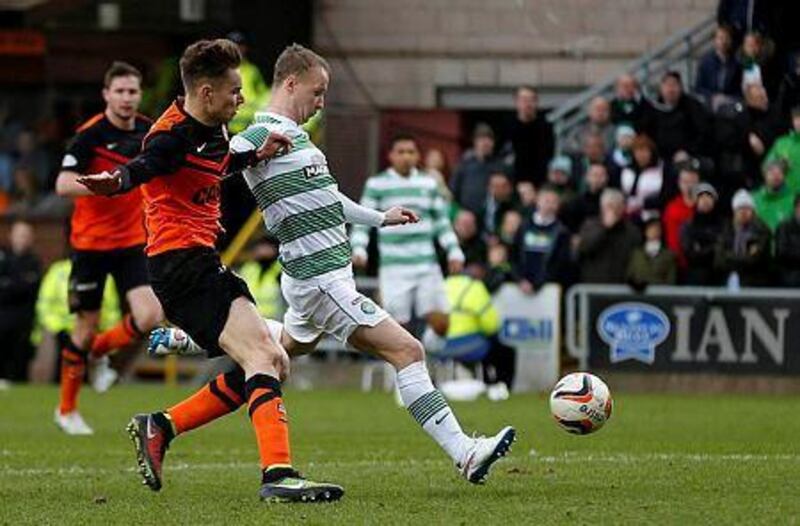Celtic's Leigh Griffiths, right, scores against Dundee United during their Scottish Premier League match at Tannadice Park Stadium in Dundee, Scotland on December 21, 2014. REUTERS/Russell Cheyne