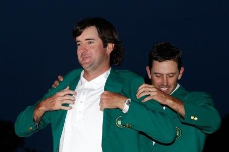 AUGUSTA, GA - APRIL 08: Bubba Watson of the United States (L) is awarded the green jacket by Charl Schwartzel of South Africa (R) during the green jacket presentation after his one-stroke playoff victory during the 2012 Masters Tournament at Augusta National Golf Club on April 8, 2012 in Augusta, Georgia.   Streeter Lecka/Getty Images/AFP== FOR NEWSPAPERS, INTERNET, TELCOS & TELEVISION USE ONLY ==
 *** Local Caption ***  267608-01-09.jpg