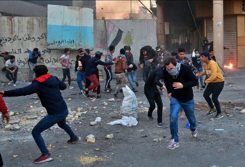 Protesters run for cover while security forces fire tear gas and live ammunition during clashes. AP Photo