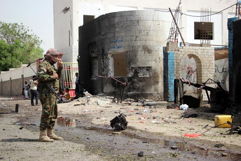 A Yemeni soldier inspects the site of a car bomb attack that targeted a police station.  EPA