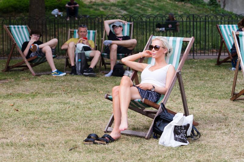 epa07740078 People relax on deckchairs during hot weather in St James's Park, London, Britain, 25 July, 2019. The UK is set to see the hottest day on record, as forecasters warn temperatures in London could soar to 39 degrees Celsius.  EPA/VICKIE FLORES